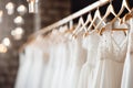 Exquisite display of beautiful and elegant luxury bridal dresses on hangers in a boutique salon