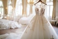 Exquisite and elegant collection of luxury bridal dresses displayed on hangers in a boutique salon