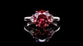 Exquisite engagement ring with a large red cushion-cut diamond or ruby. White gold or platinum. On black background with Royalty Free Stock Photo