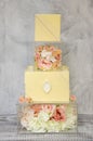 Exquisite four tiered chocolate wedding cake on glass box decorated with roses Royalty Free Stock Photo