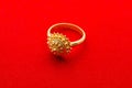 Exquisite Golden Ring on Red Background