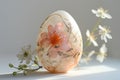 Exquisite handmade Easter egg with fresh flowers.
