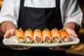 Exquisite Japanese cuisine: a chef\'s skilled hands showcase sushi rolls