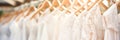 Exquisite and opulent white bridal dresses displayed on hangers in a lavish boutique salon