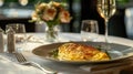 Exquisite serving of omelette for breakfast in a luxury restaurant. The table for two is elegantly set with crystal Royalty Free Stock Photo