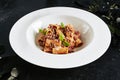 Exquisite Serving White Restaurant Plate of Homemade Rigatoni with Bolognese Sauce and Smoked Pork Belly