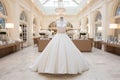 Exquisite and sophisticated white bridal gowns adorned on hangers in a lavish boutique salon