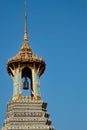 An exquisite Thai temple bell tower, featuring a luminous golden roof and captivating, colorful details, stands in all its glory