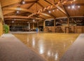 Party lights reflected onto vacant dance floor.