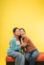 exspression of happiness two asian young woman sitting together