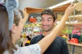 Extatic couple having fun while shopping in costume shop