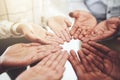 Extend a helping hand where you can. Closeup shot of a group of businesspeople standing with their hands cupped together