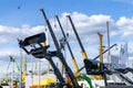 Extended booms of XCMG mobile cranes and raised buckets of mini-loaders of Bawooat the Bauma CCT Russia construction