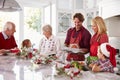 Extended Family Group Preparing Christmas Meal In Kitchen Royalty Free Stock Photo