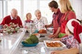 Extended Family Group Preparing Christmas Meal In Kitchen