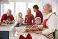Extended Family Group Preparing Christmas Meal In Kitchen Royalty Free Stock Photo