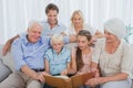 Extended family looking at an album photo Royalty Free Stock Photo