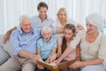 Extended family looking at their album photo Royalty Free Stock Photo