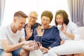 Extended family making a video call and waving at the caller. Asian multi generation family with senior and young couple together