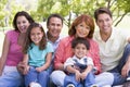 Extended family sitting outdoors smiling Royalty Free Stock Photo