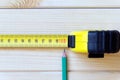 Extended measuring tape and a simple pencil Royalty Free Stock Photo