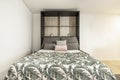 Extended pull-out bed with cushions, plant-print blankets Royalty Free Stock Photo