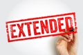 EXTENDED stamp text shown in bold rectangular frame, hand holding marker emphasizing continuation, prolonged deadline concept, Royalty Free Stock Photo