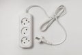 Extension cord for three sockets with a long coiled cord