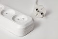 Extension cord for three sockets with a long coiled cord on a white background Royalty Free Stock Photo