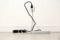 Extension cords with power plugs in socket. Electrician`s professional equipment