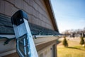 Extension step ladder against side of roof with a strand of Christmas lights Royalty Free Stock Photo