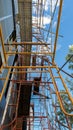 Extensive scaffolding as a base for construction workers High rise building under construction with scaffolding, worker fire safe Royalty Free Stock Photo