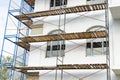Extensive scaffolding for building a new house. Constraction of platforms for building works Royalty Free Stock Photo