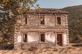 Exterior of an abandoned old brown stone house with trees with sunlight Royalty Free Stock Photo