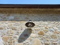 Exterior antique lamp on stone facade. Bottom view of vintage iron lantern. Architecture and construction