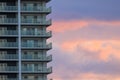 Exterior balconies on luxury apartment tower with beautiful sunset sky Royalty Free Stock Photo