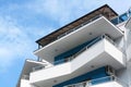 Exterior of beautiful building with balconies against blue sky, low angle view Royalty Free Stock Photo