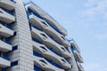 Exterior of beautiful building with balconies against blue sky, low angle view. Space for text Royalty Free Stock Photo