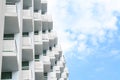 Exterior of beautiful building with balconies against blue sky, low angle view. Space for text Royalty Free Stock Photo