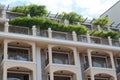 Exterior of beautiful building with balconies decorated with green plants against blue sky, low angle view Royalty Free Stock Photo