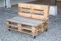 Exterior bench diy industrial recycled made from old wooden storage pallets Royalty Free Stock Photo