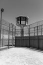 Exterior vertical shot of prison yard with guard tower Royalty Free Stock Photo