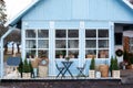 Exterior blue house with a beautiful terrace decoration green plants. Cozy Rustic House in country. Facade home with wicker basket