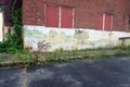 Exterior of boarded up and abandoned brick asylum hospital building with broken windows Royalty Free Stock Photo