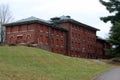 Exterior of boarded up and abandoned brick asylum hospital building with broken windows Royalty Free Stock Photo