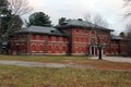 Exterior of boarded up and abandoned brick asylum hospital building with broken windows Royalty Free Stock Photo