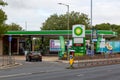 The exterior of a BP petrol station or gas station with a car entering the forecourt