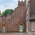 Exterior brick building with multiple windows and a doorway