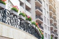 Exterior of building with balconies decorated with beautiful flowers, low angle view Royalty Free Stock Photo