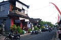 Exterior building at outdoor and traffic road balinese people and indonesian travelers riding biking driving on small street at Royalty Free Stock Photo